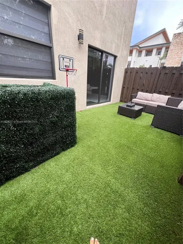 an empty room with wooden floor and white walls