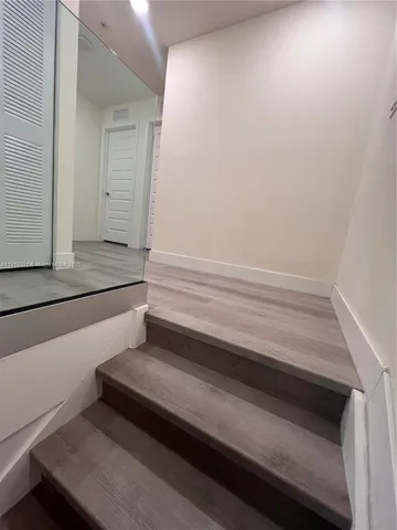 a bedroom with a bed and flat screen tv