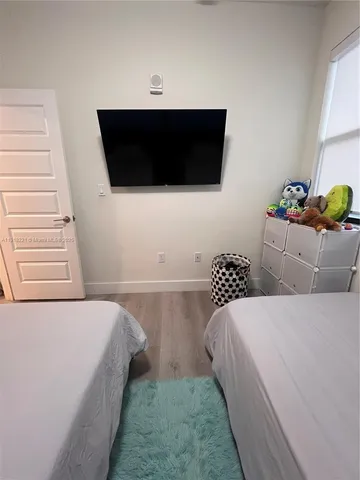 a bedroom with a bed and a couch