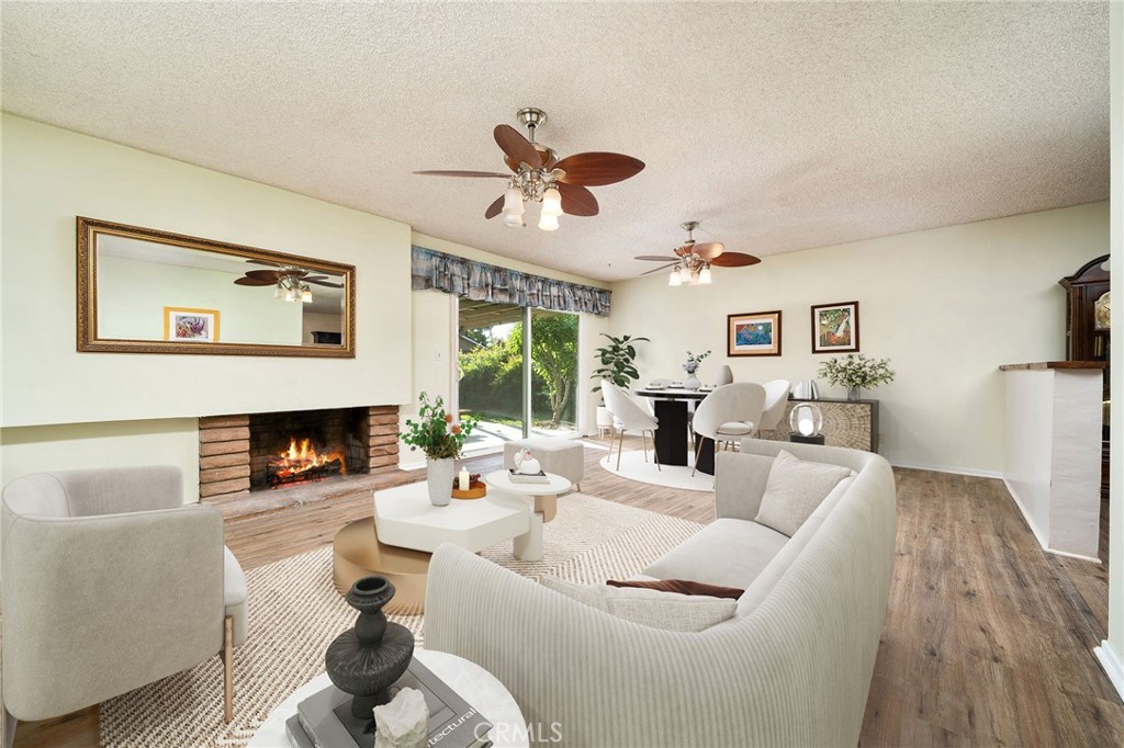 211 Benicia Road Diamond Bar, CA 91765 - Photo 4 of 24 a living room with furniture a fireplace and a flat screen tv