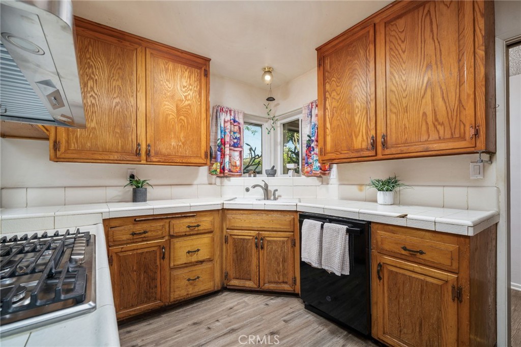 211 Benicia Road Diamond Bar, CA 91765 - Photo 7 of 24 a kitchen with a sink stove and cabinets