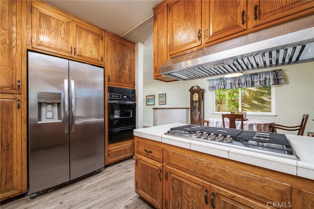 211 Benicia Road Diamond Bar, CA 91765 - Photo 8 of 24 a kitchen with stainless steel appliances granite countertop a refrigerator a sink and a stove