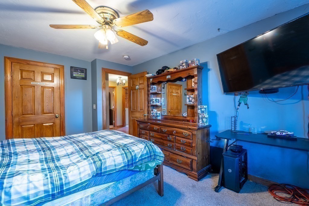 74 Katrina Road Middleboro, MA 02346 - Photo 18 of 37 a bedroom with a bed and a flat tv screen on dresser
