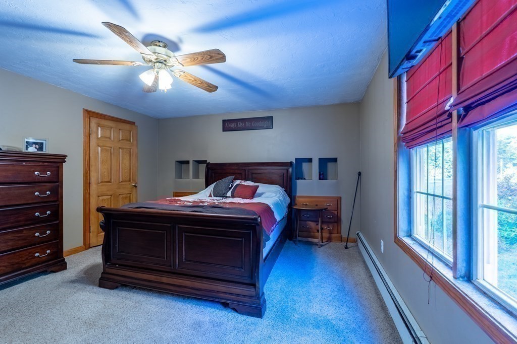 74 Katrina Road Middleboro, MA 02346 - Photo 26 of 37 a spacious bedroom with a bed and a chandelier