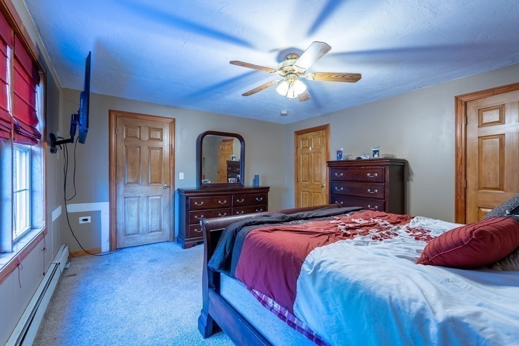 74 Katrina Road Middleboro, MA 02346 - Photo 27 of 37 a bedroom with a bed and a chandelier