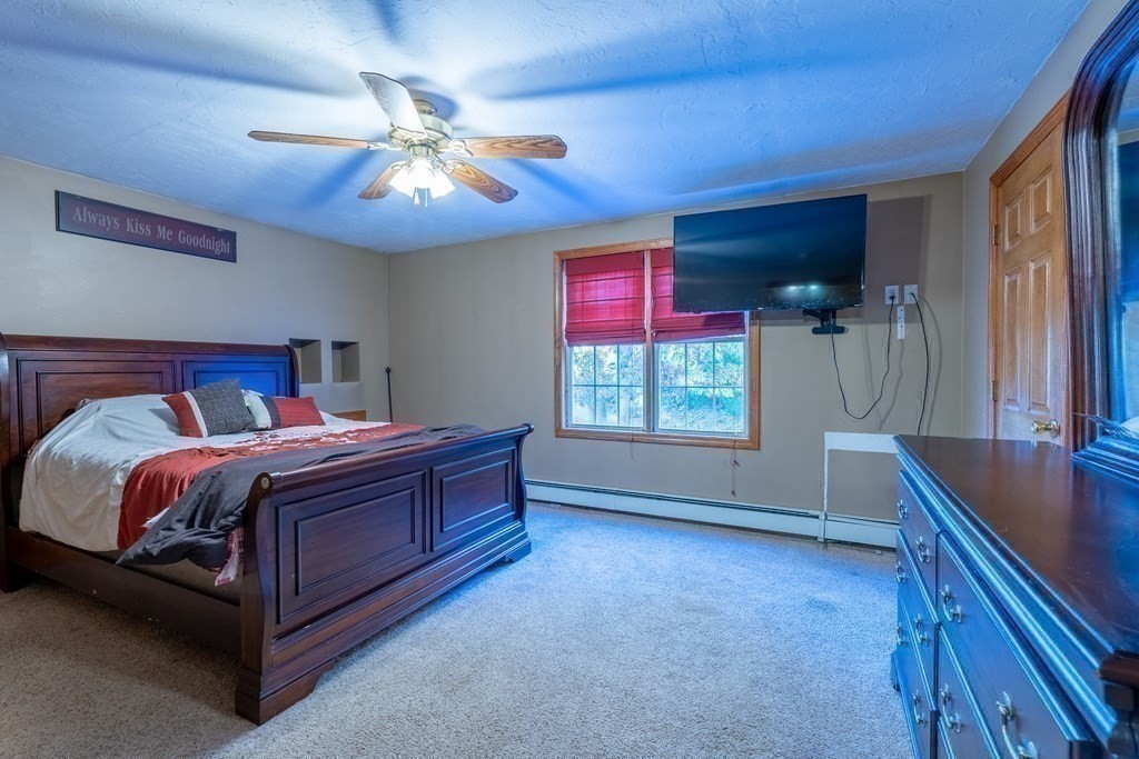 74 Katrina Road Middleboro, MA 02346 - Photo 28 of 37 a bed room with a bed and a chandelier