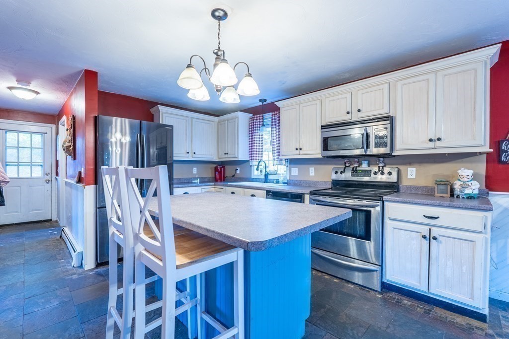 74 Katrina Road Middleboro, MA 02346 - Photo 8 of 37 a kitchen with stainless steel appliances granite countertop a stove refrigerator sink cabinets dining table and chairs