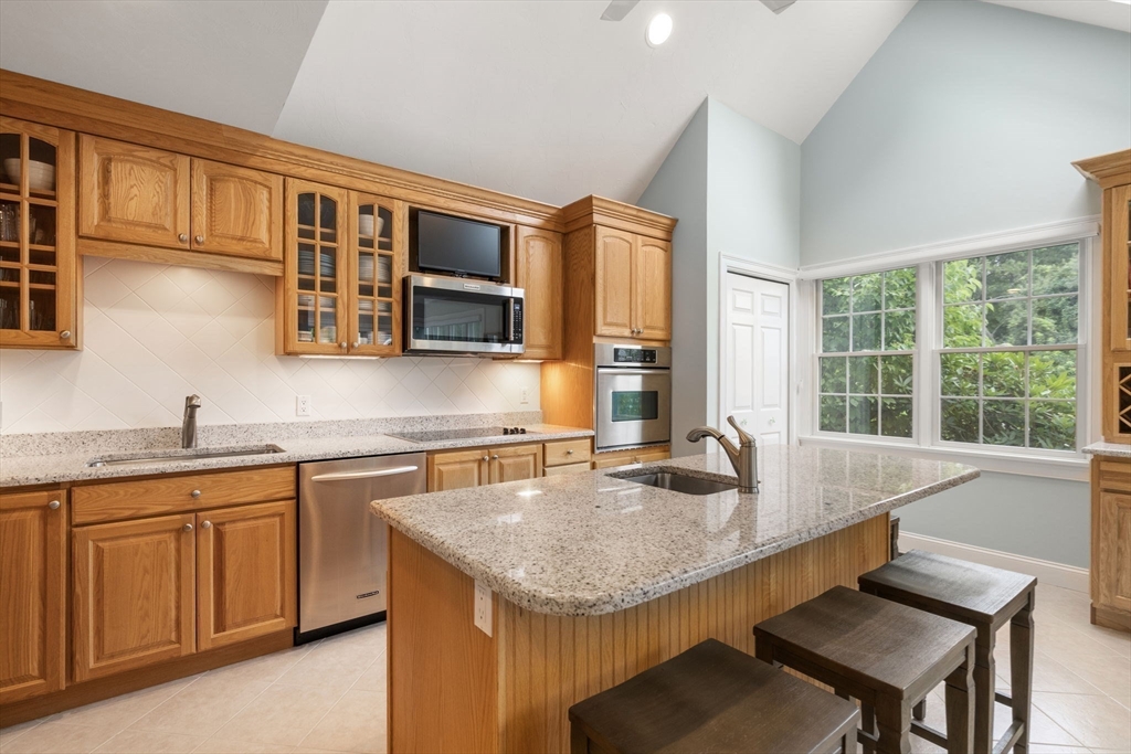 64 Gold Leaf Lane, Unit 64 Mashpee, MA 02649 - Photo 12 of 38 a kitchen with granite countertop a sink and cabinets