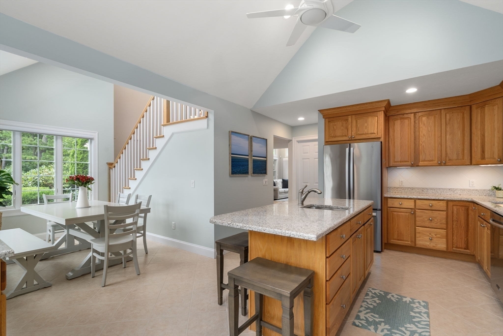 64 Gold Leaf Lane, Unit 64 Mashpee, MA 02649 - Photo 15 of 38 a dining hall with stainless steel appliances granite countertop furniture a stove a sink and a refrigerator