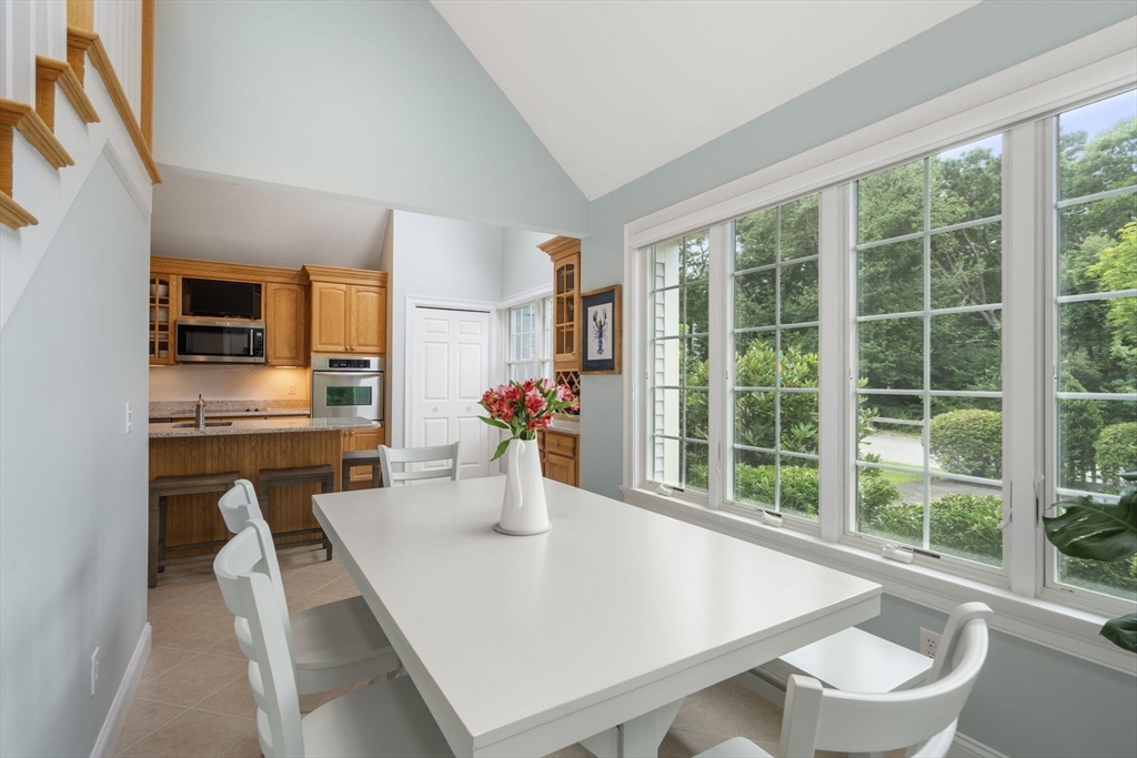 64 Gold Leaf Lane, Unit 64 Mashpee, MA 02649 - Photo 17 of 38 a view of kitchen with dining area refrigerator and window