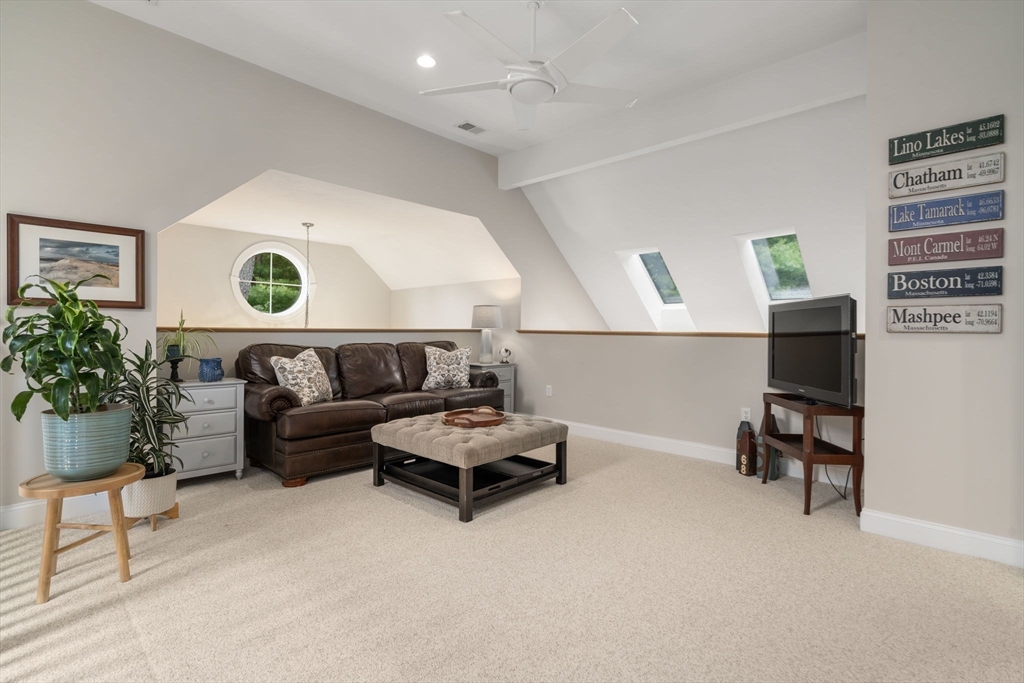64 Gold Leaf Lane, Unit 64 Mashpee, MA 02649 - Photo 22 of 38 a living room with furniture and a potted plant