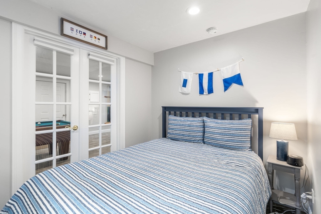 64 Gold Leaf Lane, Unit 64 Mashpee, MA 02649 - Photo 26 of 38 a bedroom with a large bed and a window