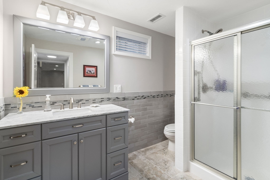 64 Gold Leaf Lane, Unit 64 Mashpee, MA 02649 - Photo 27 of 38 a bathroom with a sink a toilet and shower