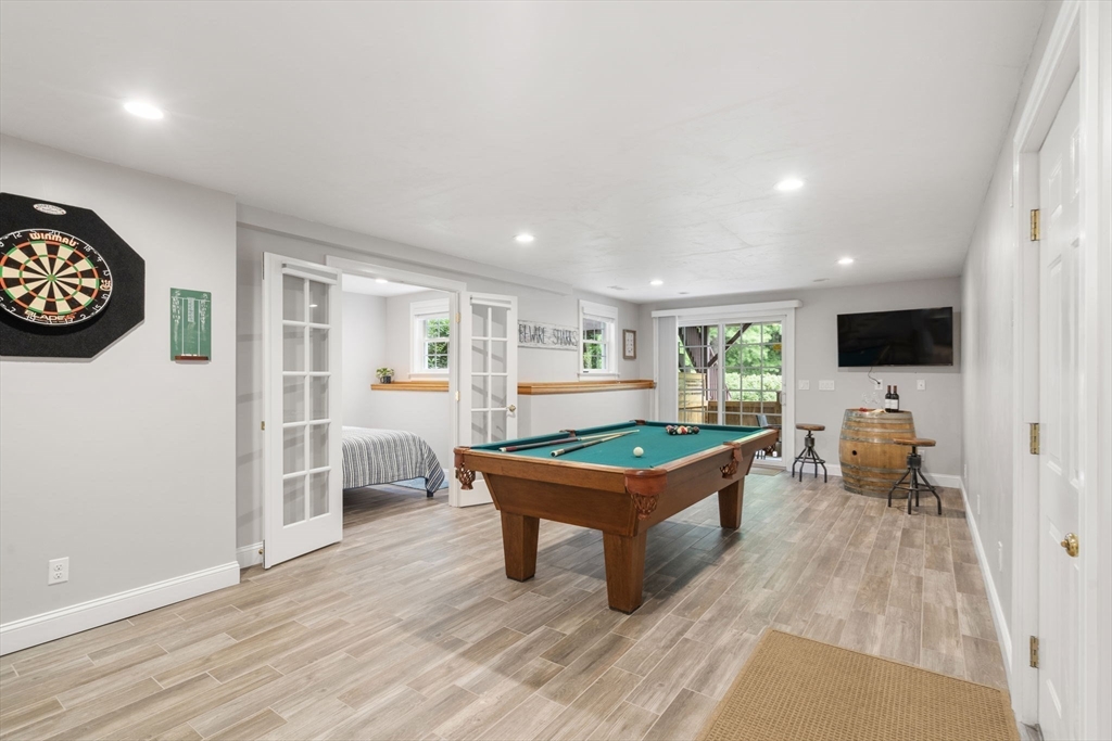 64 Gold Leaf Lane, Unit 64 Mashpee, MA 02649 - Photo 28 of 38 a room with furniture and a flat screen tv