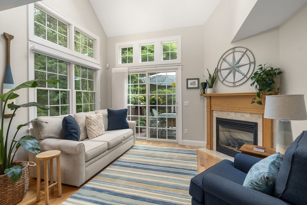64 Gold Leaf Lane, Unit 64 Mashpee, MA 02649 - Photo 7 of 38 a living room with furniture a fireplace and windows