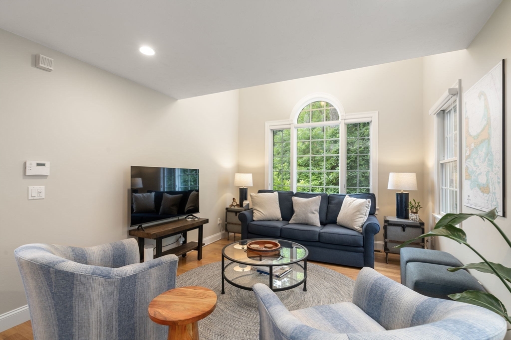 64 Gold Leaf Lane, Unit 64 Mashpee, MA 02649 - Photo 8 of 38 a living room with furniture and a large window