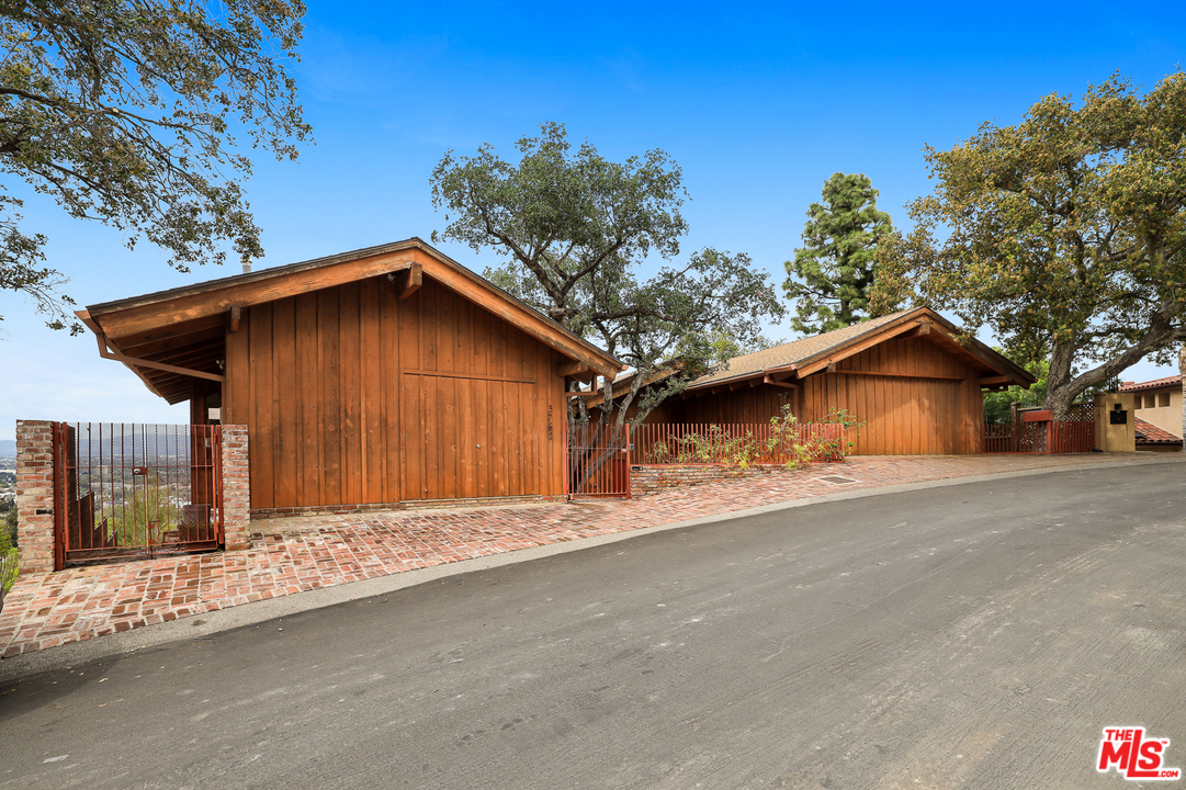 3762 Alta Mesa Drive Studio City, CA 91604 - Photo 2 of 33 a wooden house with tree in the background