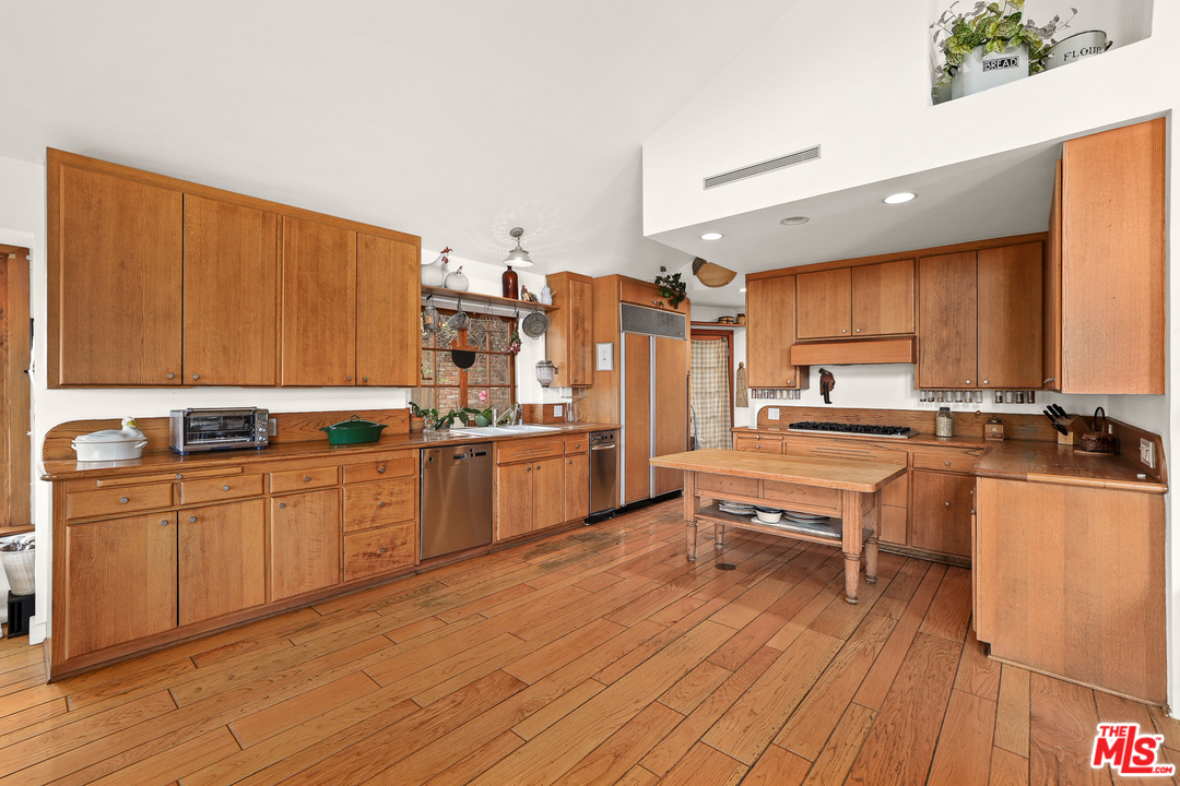 3762 Alta Mesa Drive Studio City, CA 91604 - Photo 11 of 33 a kitchen with stainless steel appliances a stove a sink dishwasher and a refrigerator