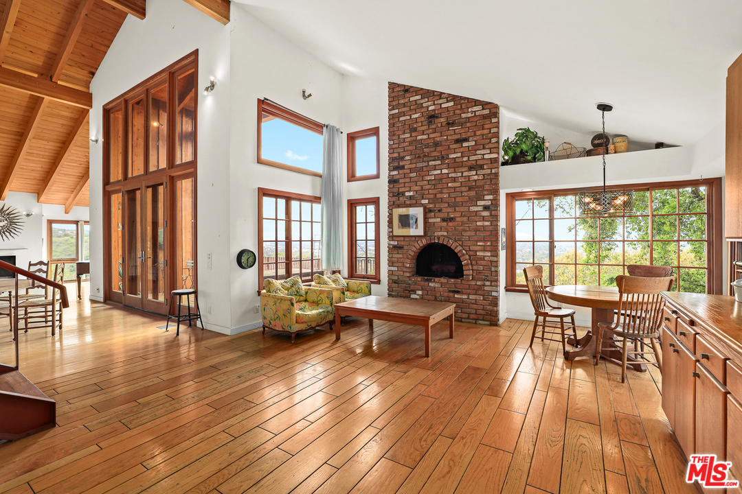 3762 Alta Mesa Drive Studio City, CA 91604 - Photo 13 of 33 a living room with furniture two large window and wooden floor