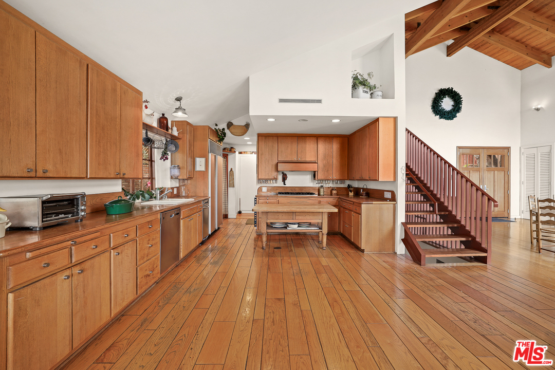 3762 Alta Mesa Drive Studio City, CA 91604 - Photo 14 of 33 a kitchen with stainless steel appliances a stove a sink and a refrigerator