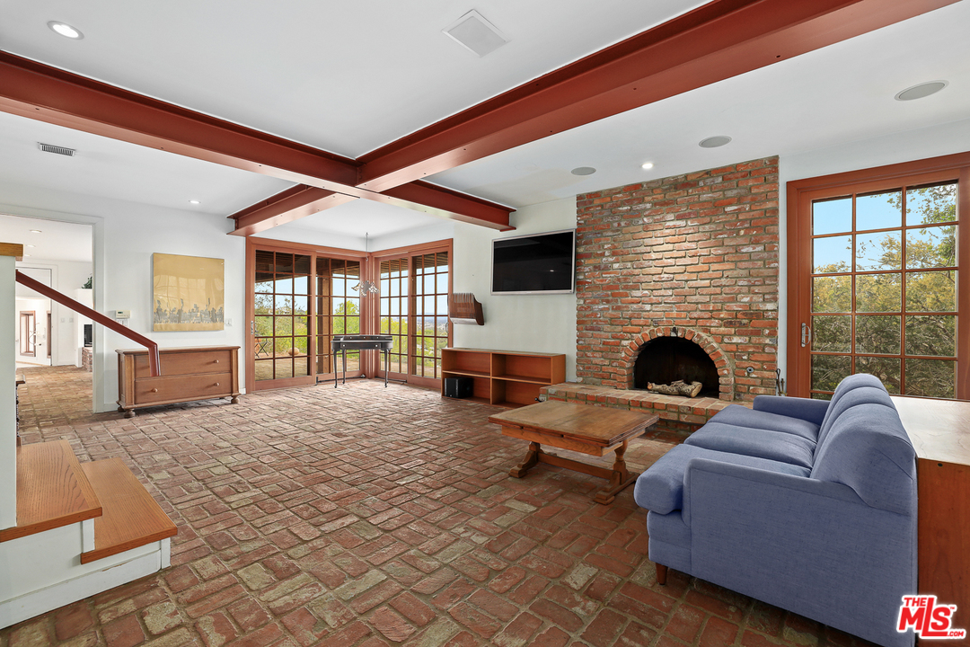 3762 Alta Mesa Drive Studio City, CA 91604 - Photo 15 of 33 a living room with furniture large window and a fireplace