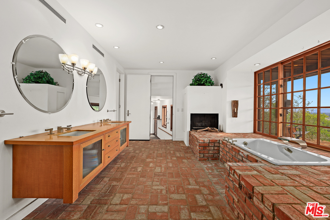3762 Alta Mesa Drive Studio City, CA 91604 - Photo 18 of 33 a spacious bathroom with a double vanity sink and a mirror
