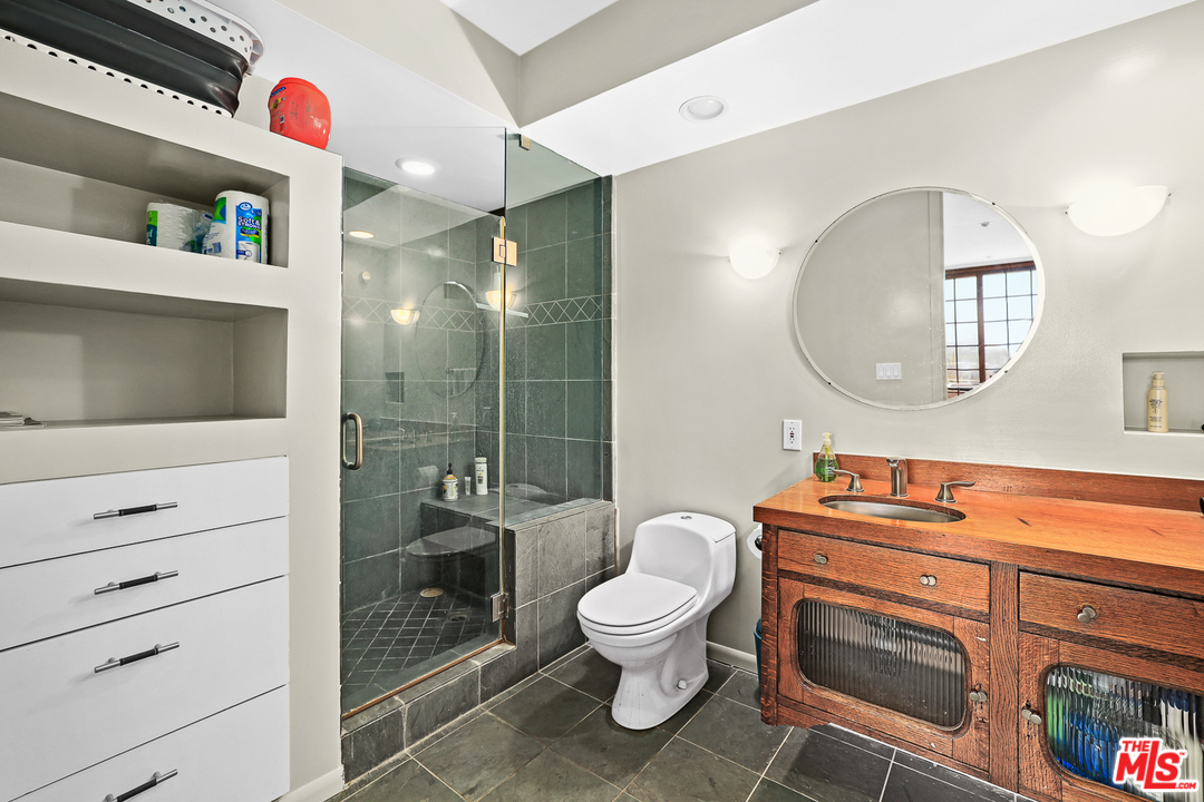 3762 Alta Mesa Drive Studio City, CA 91604 - Photo 23 of 33 a bathroom with a toilet a sink and a mirror