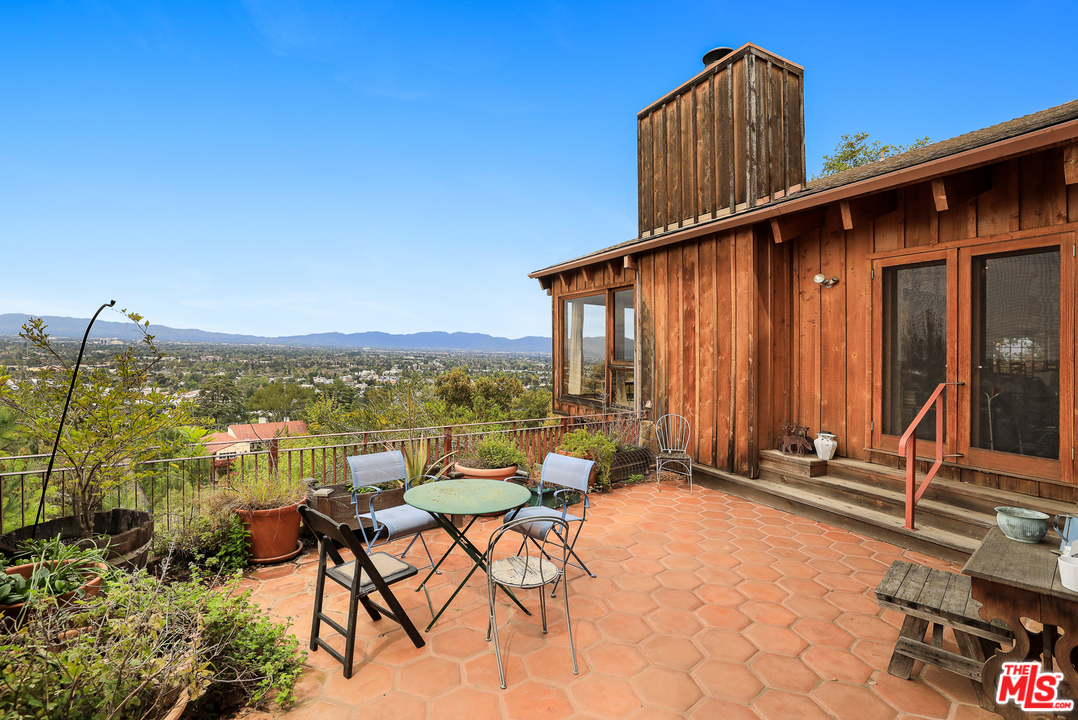 3762 Alta Mesa Drive Studio City, CA 91604 - Photo 32 of 33 a view of a balcony with chairs and a table