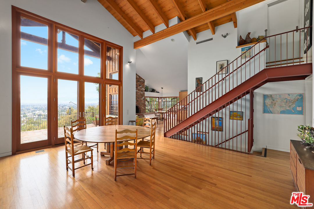 3762 Alta Mesa Drive Studio City, CA 91604 - Photo 7 of 33 a dining room with wooden floor a table and chairs