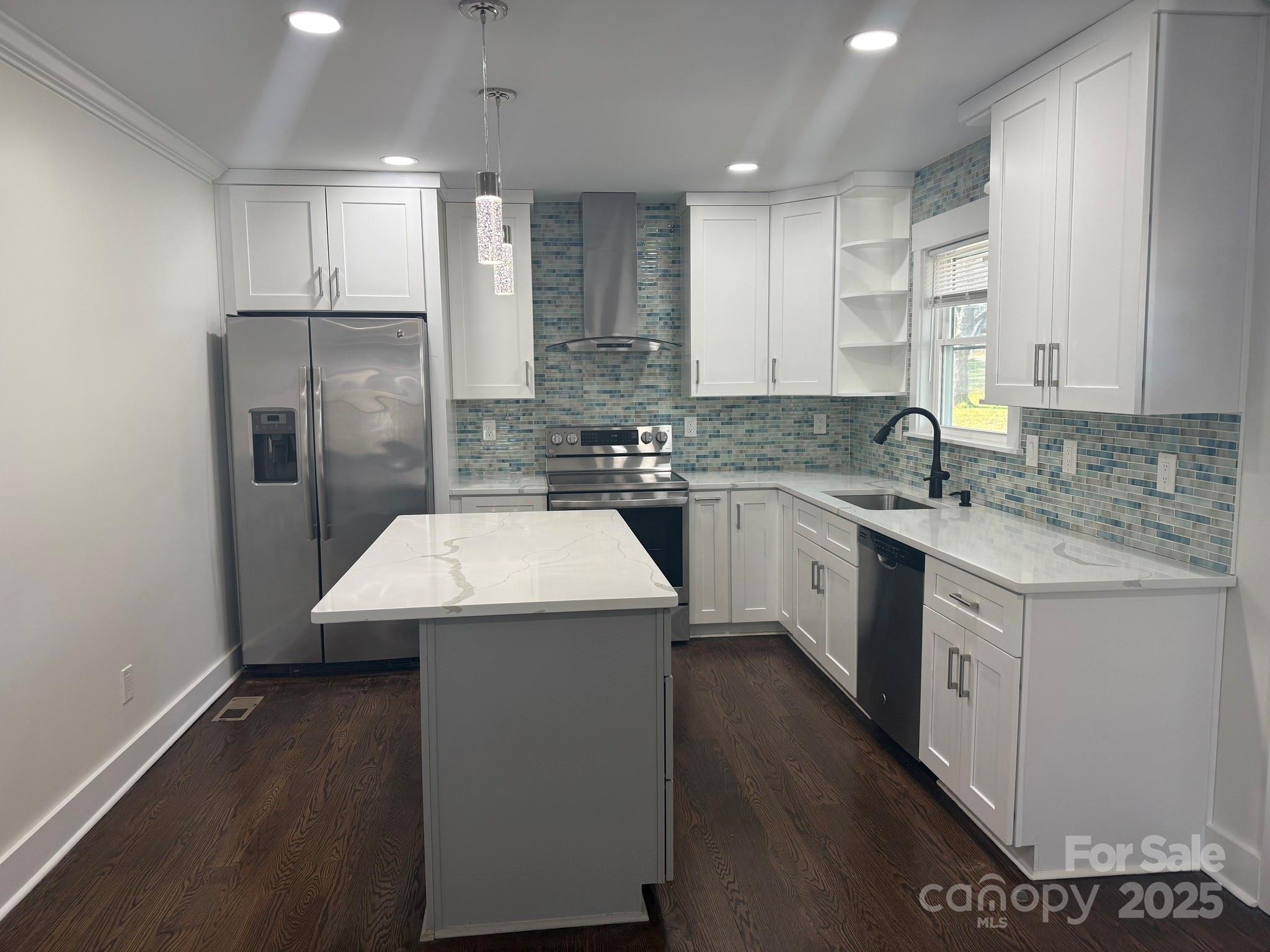 6423 South Tryon Street Charlotte, NC 28217 - Photo 14 of 28 a kitchen with a sink a stove a refrigerator and cabinets