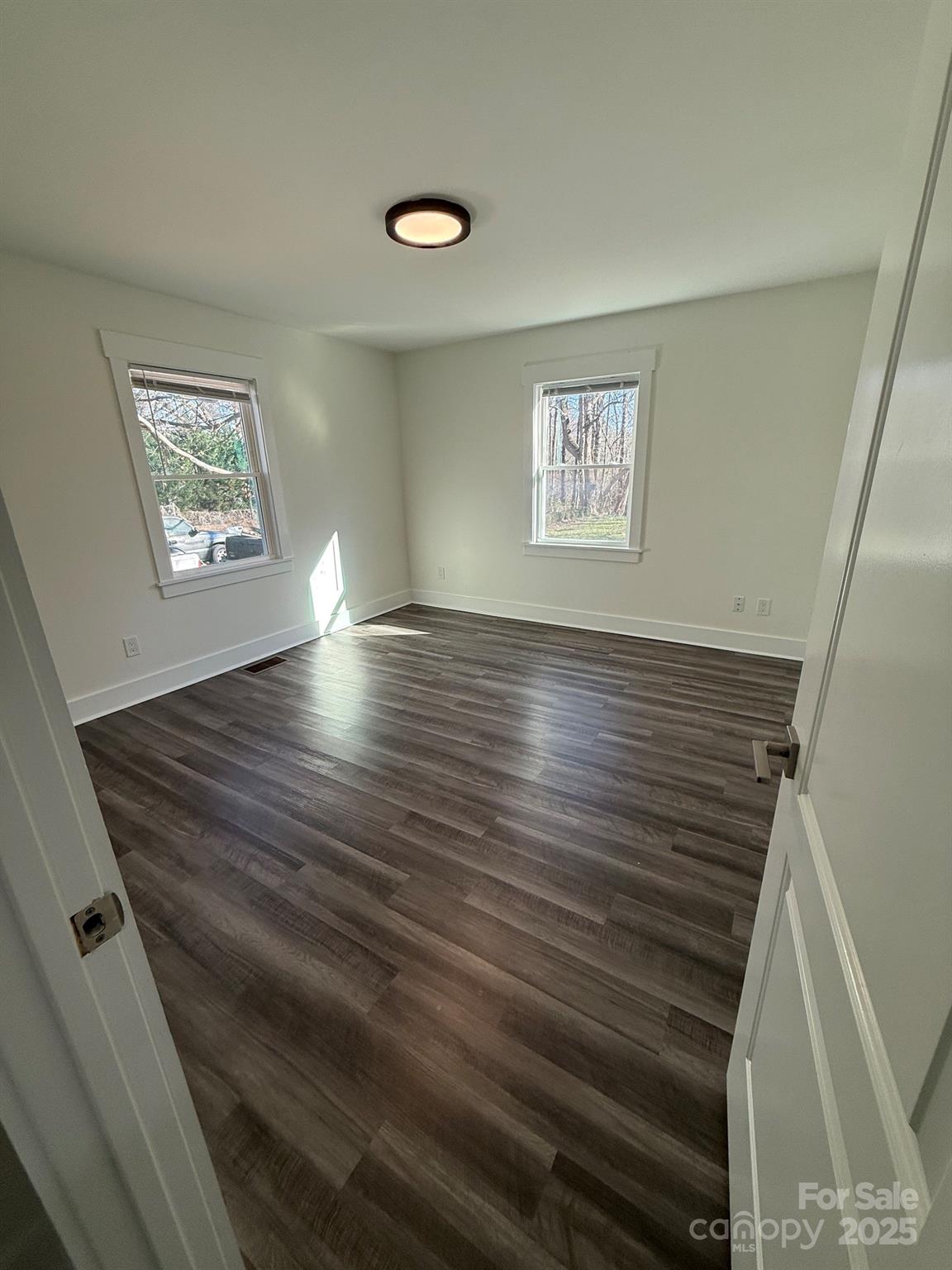 6423 South Tryon Street Charlotte, NC 28217 - Photo 16 of 28 a view of an empty room with wooden floor and a window