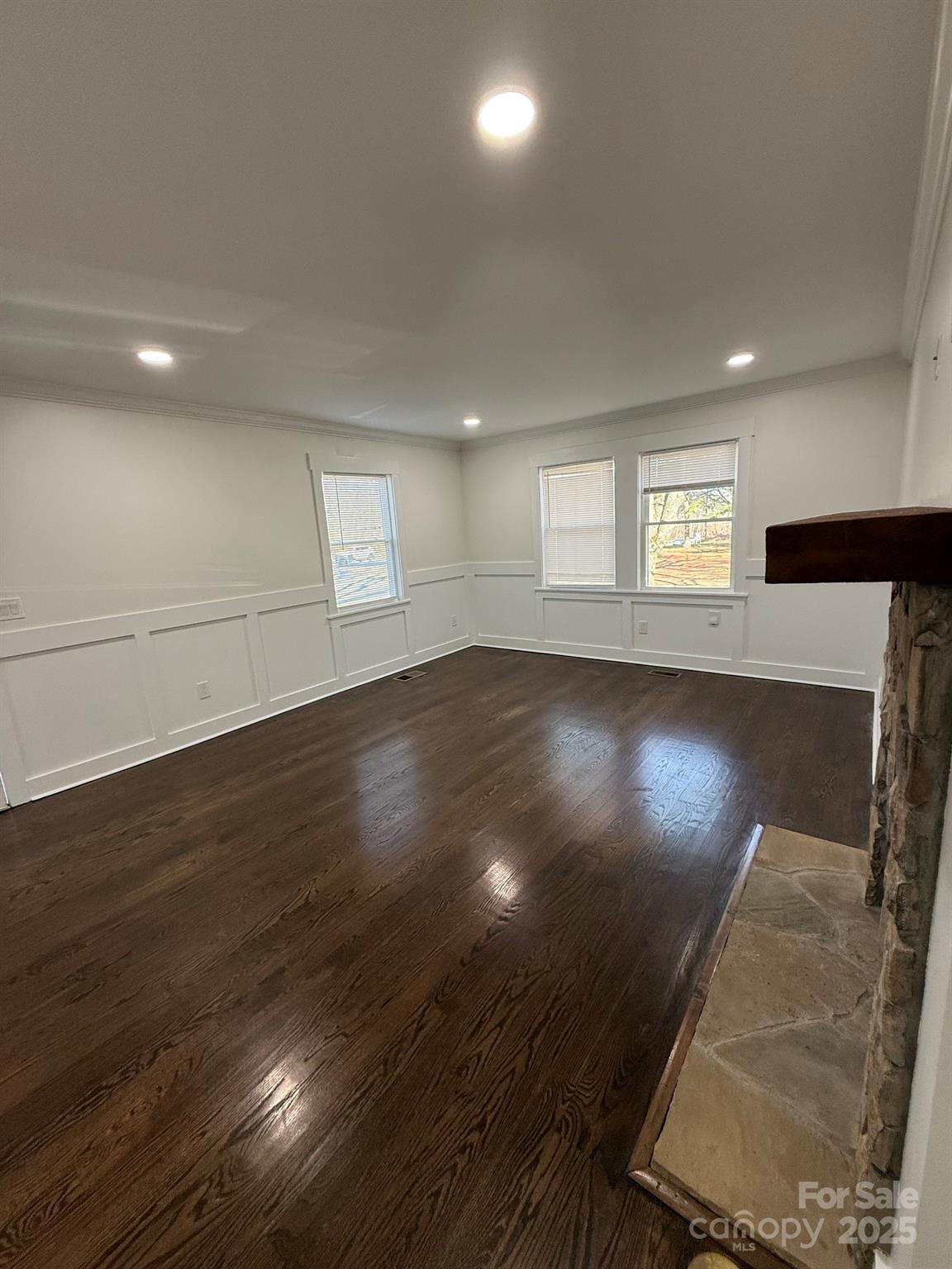 6423 South Tryon Street Charlotte, NC 28217 - Photo 19 of 28 an empty room with wooden floor and windows
