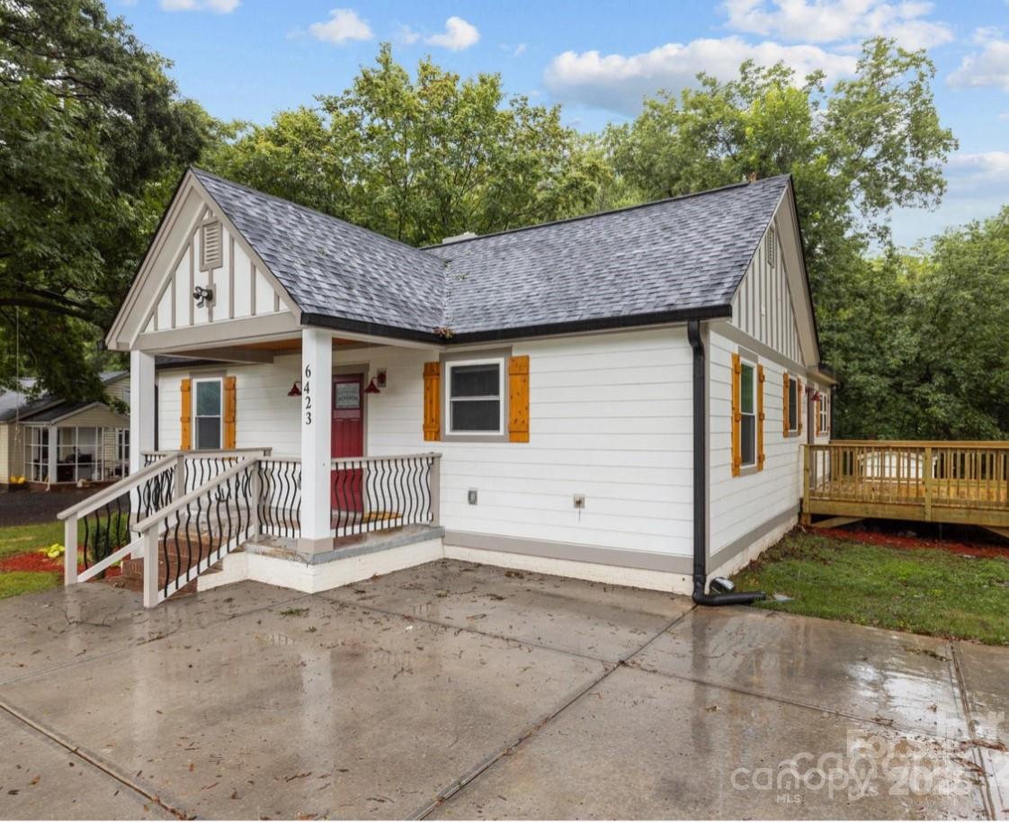 6423 South Tryon Street Charlotte, NC 28217 - Photo 3 of 28 a front view of a house with a garden