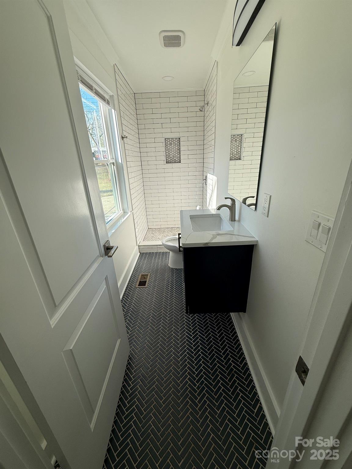6423 South Tryon Street Charlotte, NC 28217 - Photo 5 of 28 a bathroom with sink and mirror