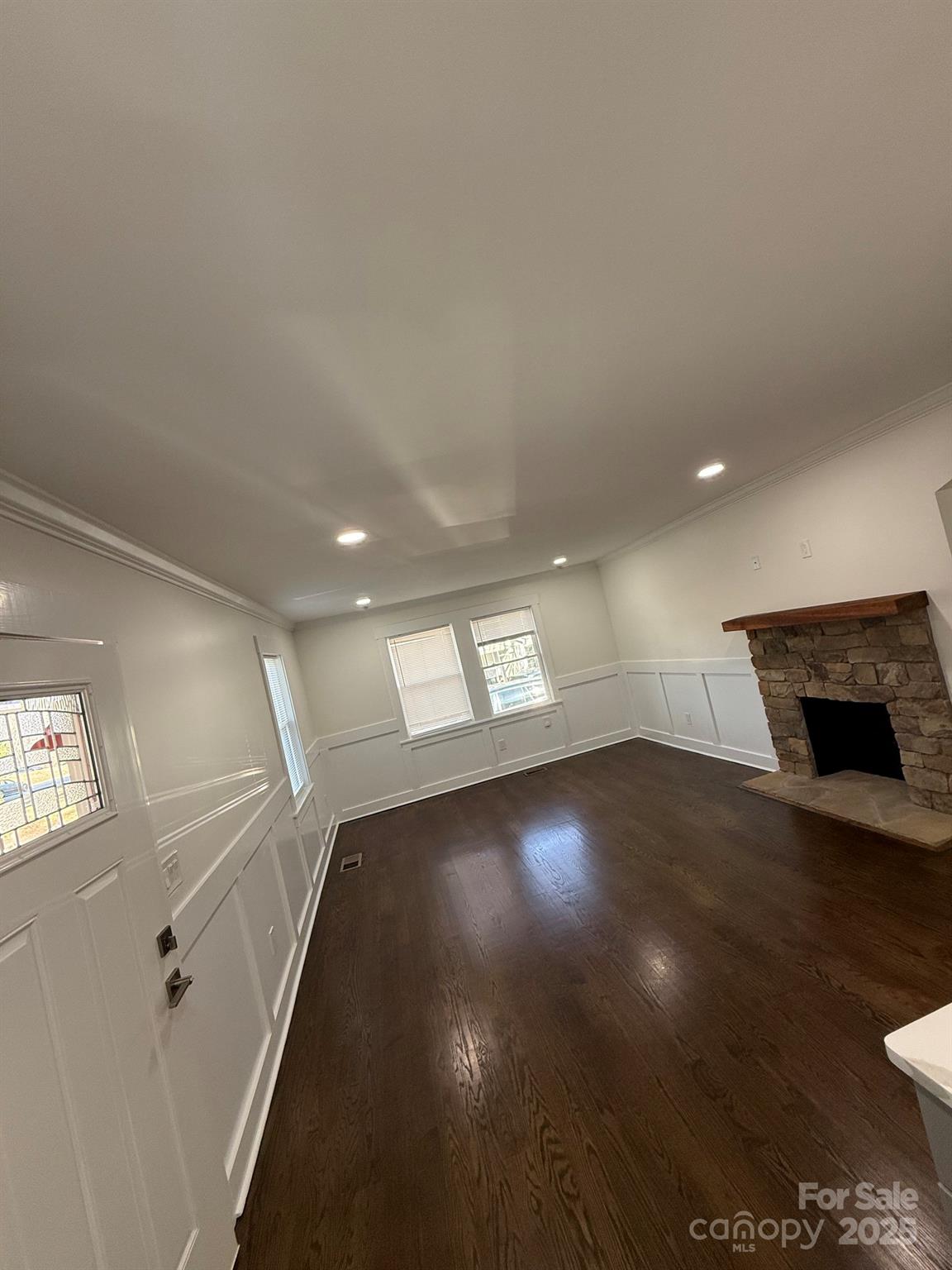 6423 South Tryon Street Charlotte, NC 28217 - Photo 7 of 28 a view of empty room with wooden floor and fan