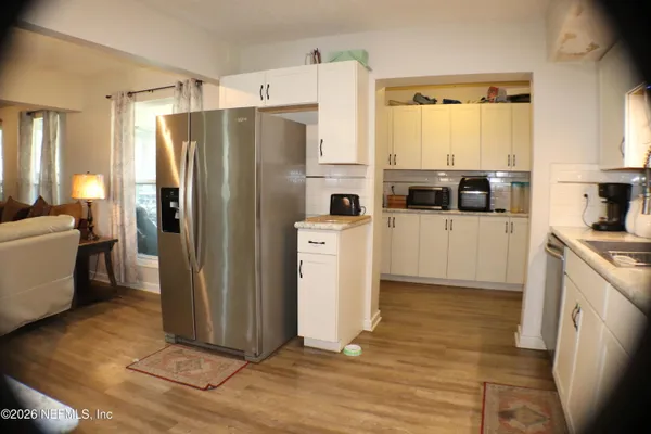 a kitchen with stainless steel appliances a refrigerator and a stove