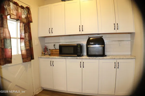 a kitchen with stainless steel appliances a white cabinets and a sink