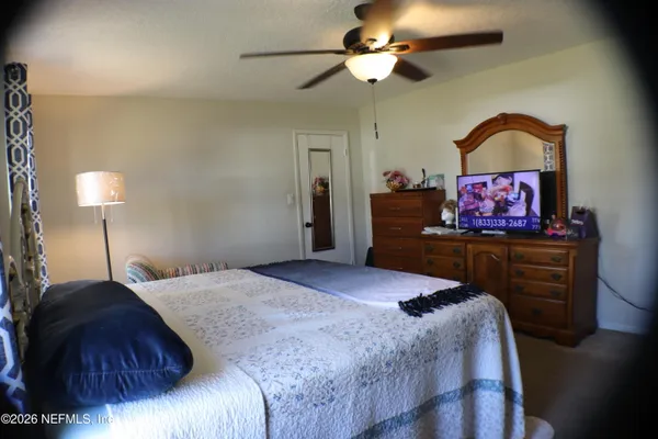 a bedroom with a bed and a chandelier