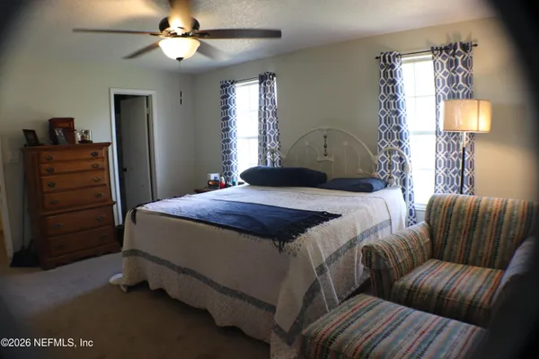 a bedroom with a bed and window