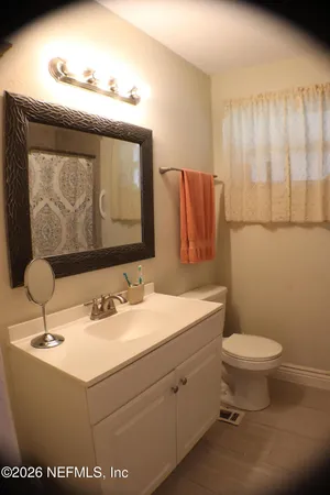 a bathroom with a sink toilet and mirror