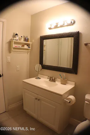 a bathroom with a sink a mirror and a toilet