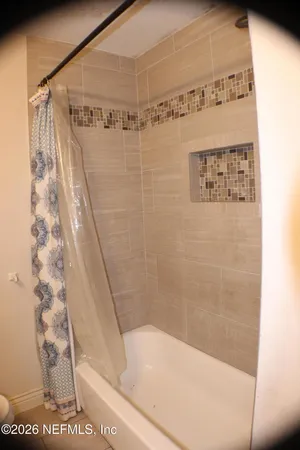 a bathroom with a shower and a bath tub