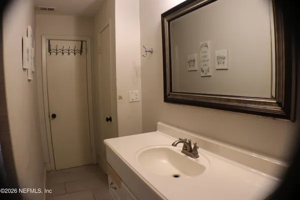 a bathroom with a sink and mirror