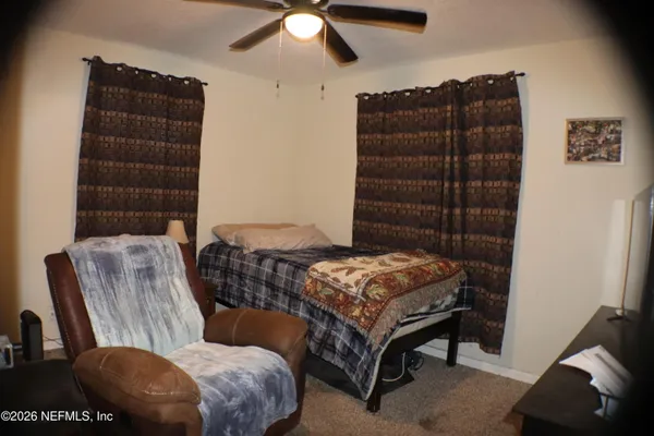 a bedroom with furniture and a chandelier