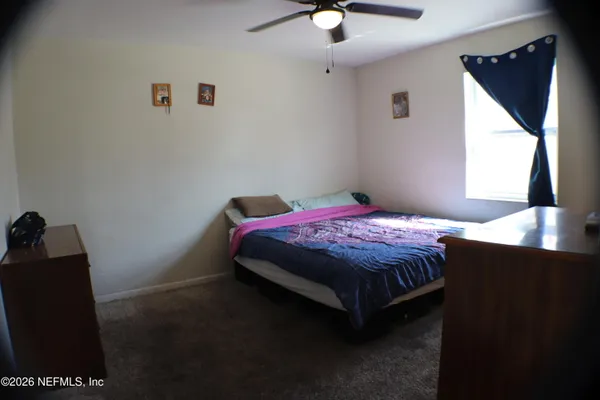 a bedroom with a bed and a mirror