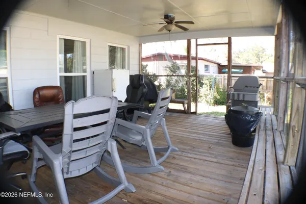 a dining room with furniture a chandelier and wooden floor