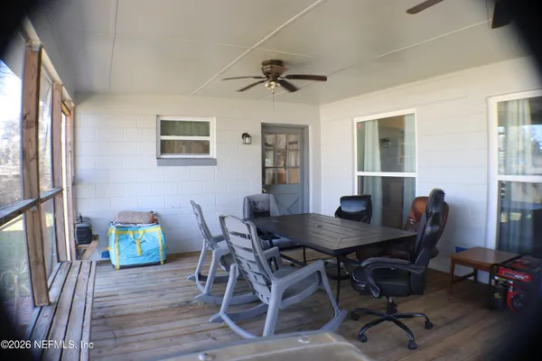 a view of a dining room with furniture and a window