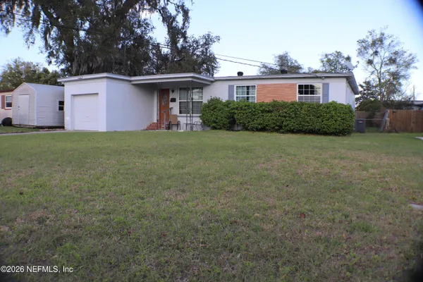 a front view of a house with a garden
