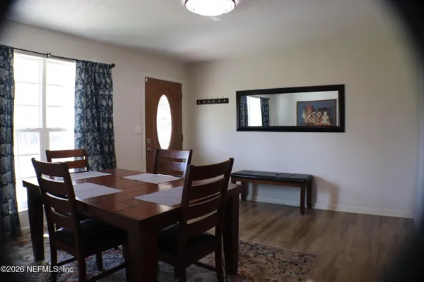 a view of a dining room with furniture and window