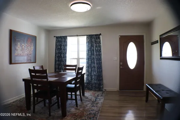 a view of a dining room with furniture and wooden floor